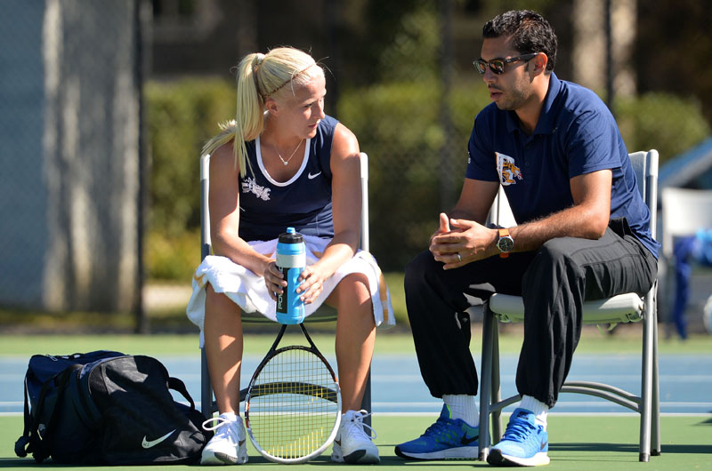Mehdi Rhazali (R), head tennis coach at Drexel, talks with a student-athlete.